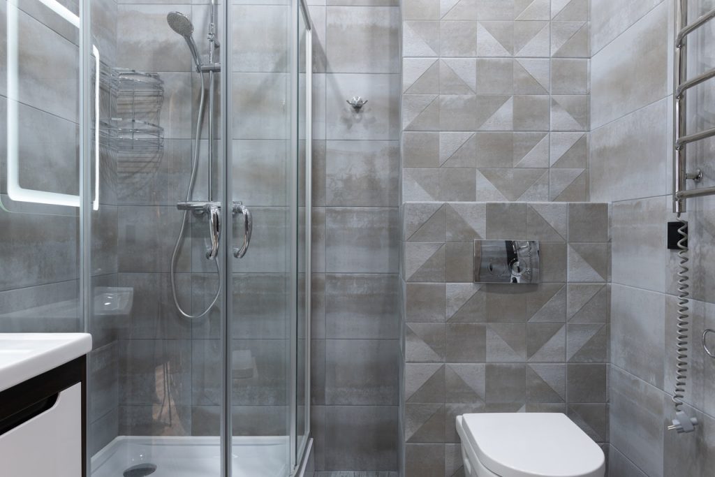 Modern shower room interior with toilet bowl at home
