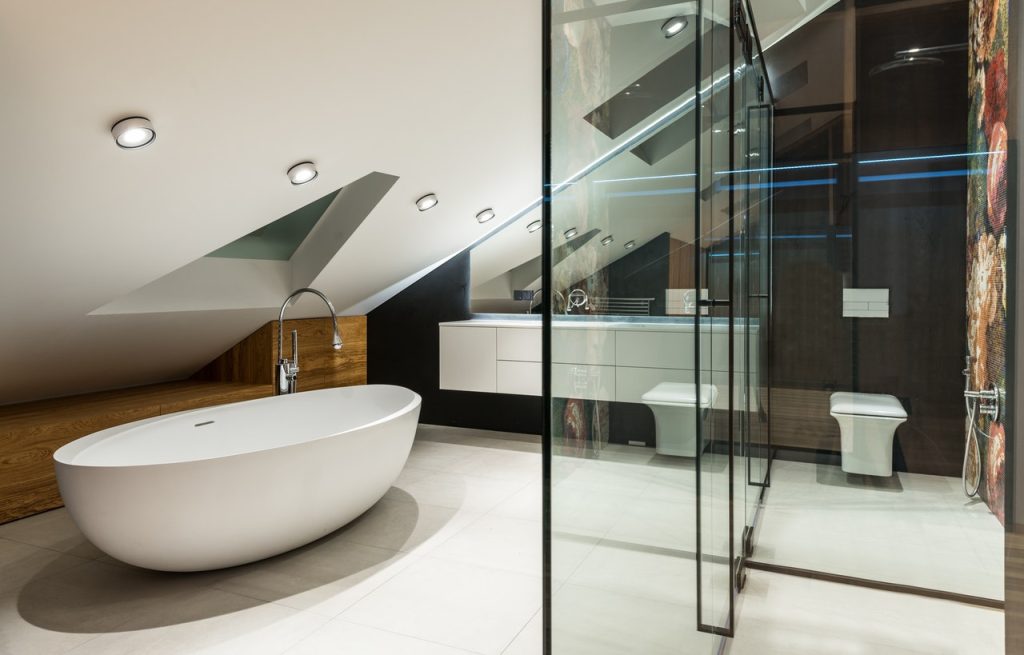 Modern bathroom interior with bathtub and toilet bowl at home