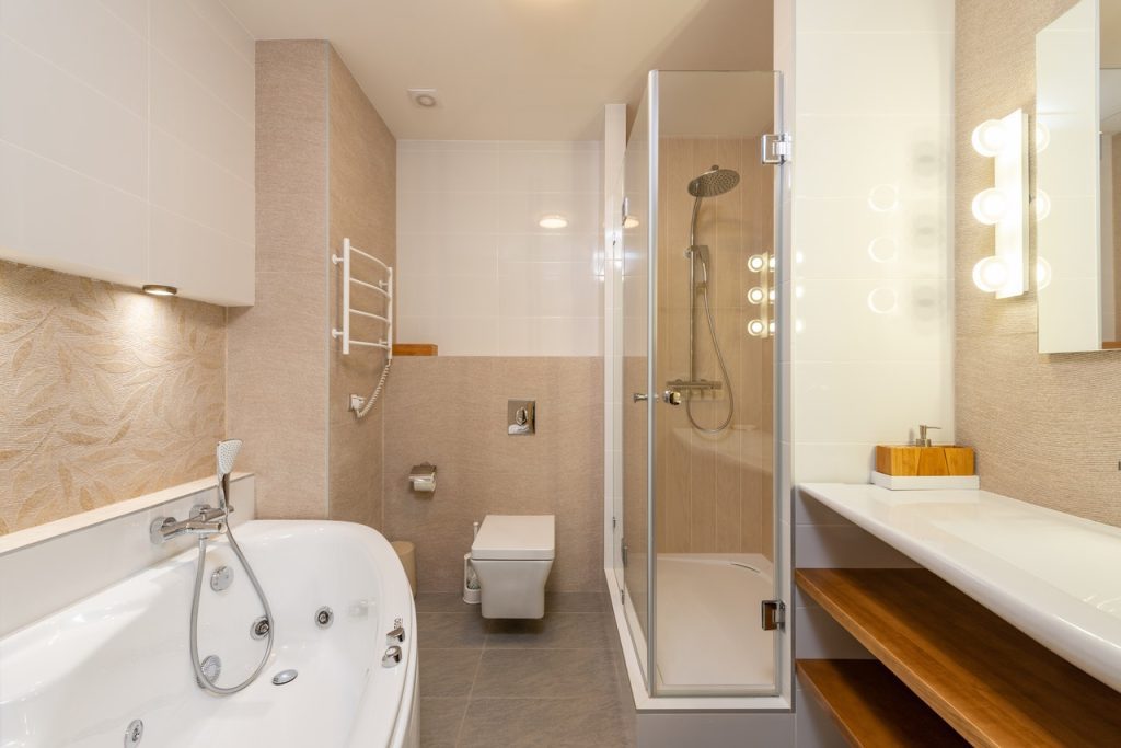Interior of Modern Bathroom with Bathtub and Enclosed Shower